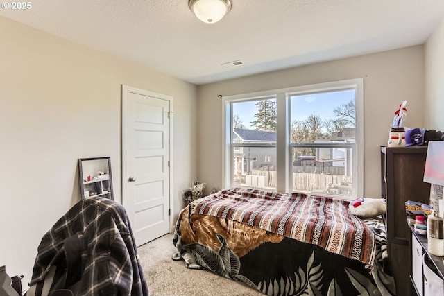 carpeted bedroom featuring a textured ceiling