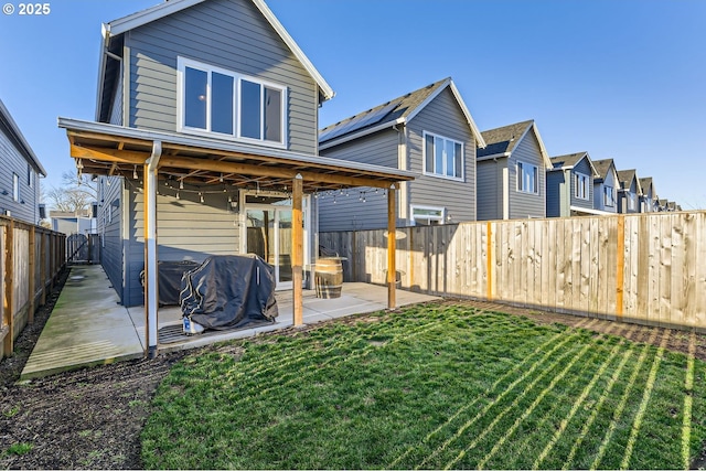 back of property featuring a patio and a lawn