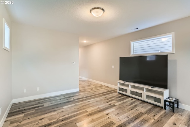 living room featuring wood-type flooring and plenty of natural light