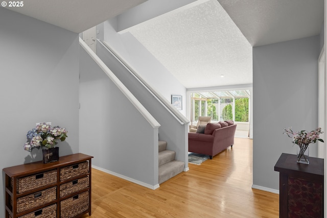 7409 SW Locust St, Portland, OR 97223 - stairway with wood finished floors, baseboards, and a textured ceiling