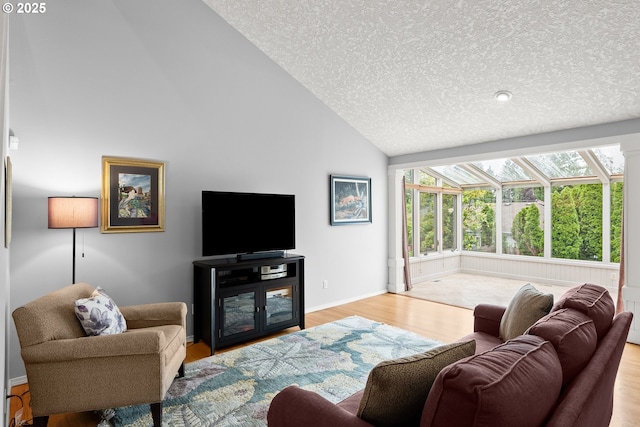 7409 SW Locust St, Portland, OR 97223 - living area featuring a textured ceiling, wood finished floors, high vaulted ceiling, and baseboards