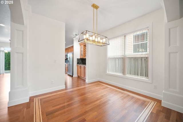2530 NW 22nd Ave, Camas, WA 98607 - unfurnished dining area featuring light wood-style floors, baseboards, and a chandelier
