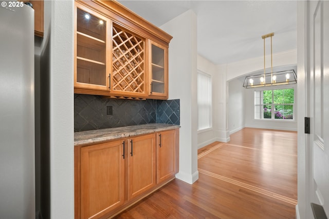 2530 NW 22nd Ave, Camas, WA 98607 - indoor dry bar featuring light wood finished floors, refrigerator, tasteful backsplash, a chandelier, and baseboards