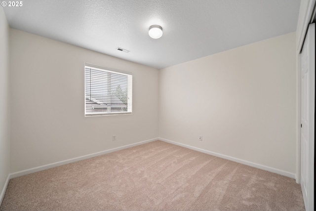 2530 NW 22nd Ave, Camas, WA 98607 - unfurnished room featuring light carpet, baseboards, and a textured ceiling