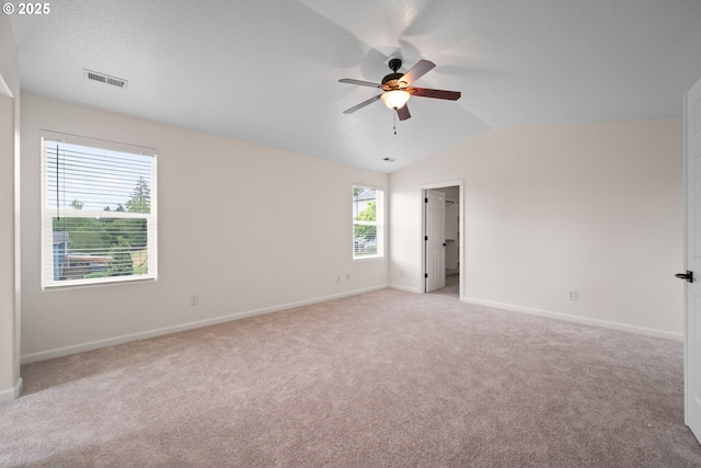 2530 NW 22nd Ave, Camas, WA 98607 - unfurnished bedroom featuring light carpet, baseboards, lofted ceiling, ceiling fan, and a walk in closet
