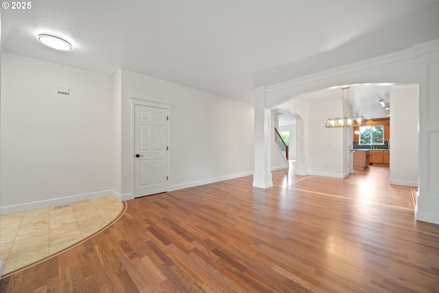 2530 NW 22nd Ave, Camas, WA 98607 - unfurnished room featuring arched walkways, light wood-type flooring, baseboards, and a chandelier