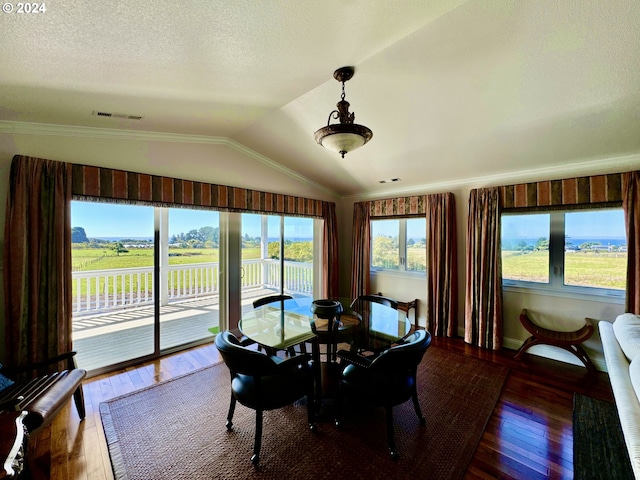 98694 Woodriff Ln, Brookings, OR 97415 - dining space with crown molding, vaulted ceiling, and hardwood / wood-style flooring