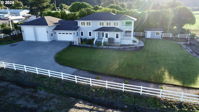 98694 Woodriff Ln, Brookings, OR 97415 - view of front facade with driveway, an outbuilding, fence, a garage, and a front yard