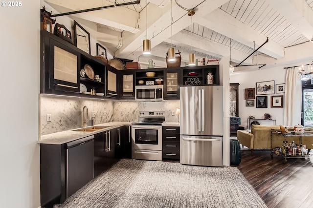 1420 NW Lovejoy St Unit 327, Portland, OR 97209 - kitchen featuring stainless steel appliances, open shelves, dark wood-type flooring, dark cabinets, and backsplash