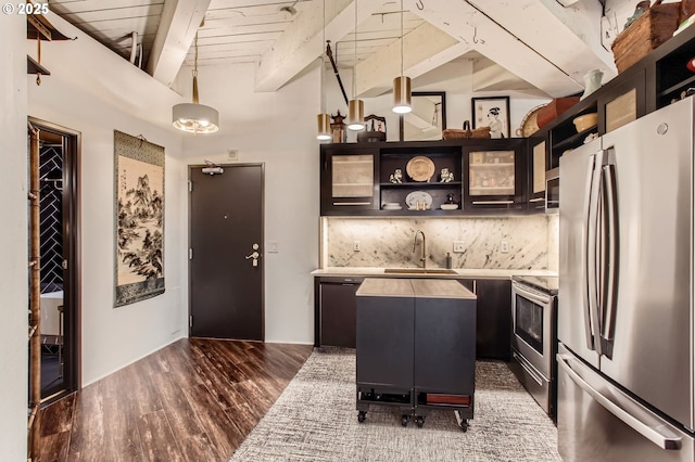 1420 NW Lovejoy St Unit 327, Portland, OR 97209 - kitchen featuring stainless steel appliances, open shelves, tasteful backsplash, dark wood-style flooring, and light countertops