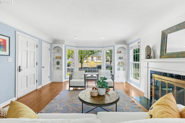 6611 SE 40th Ave, Portland, OR 97202 - living area featuring wood finished floors, plenty of natural light, a high end fireplace, recessed lighting, and ornamental molding