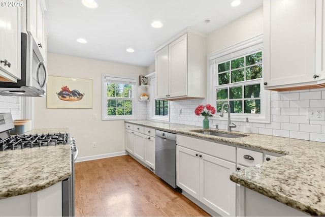 6611 SE 40th Ave, Portland, OR 97202 - kitchen with appliances with stainless steel finishes, white cabinetry, healthy amount of natural light, and recessed lighting