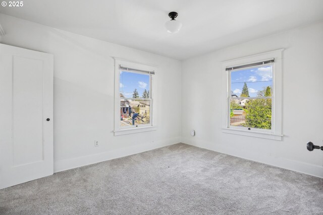 5025 NE 6th Ave, Portland, OR 97211 - unfurnished room featuring healthy amount of natural light, carpet floors, and baseboards