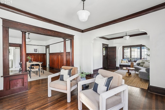 5025 NE 6th Ave, Portland, OR 97211 - living area featuring arched walkways, dark wood-type flooring, crown molding, and baseboards