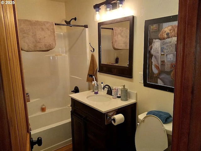 bathroom with toilet, shower / bath combination, and vanity