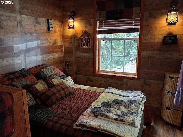 bedroom featuring wood walls and wood finished floors