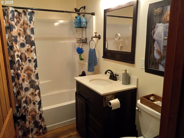 bathroom with shower / bathtub combination with curtain, vanity, toilet, and wood finished floors