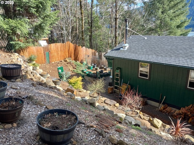 view of yard featuring an outbuilding and fence