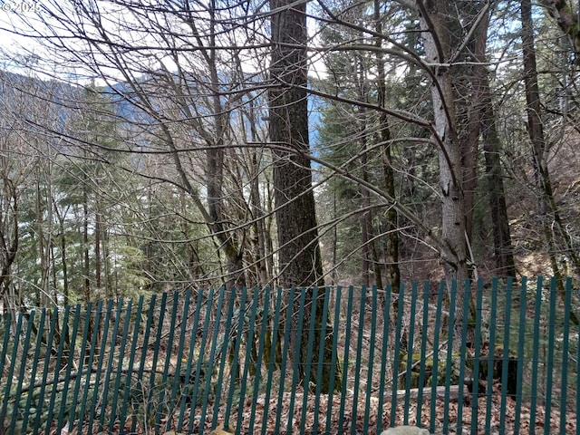 view of gate with a forest view