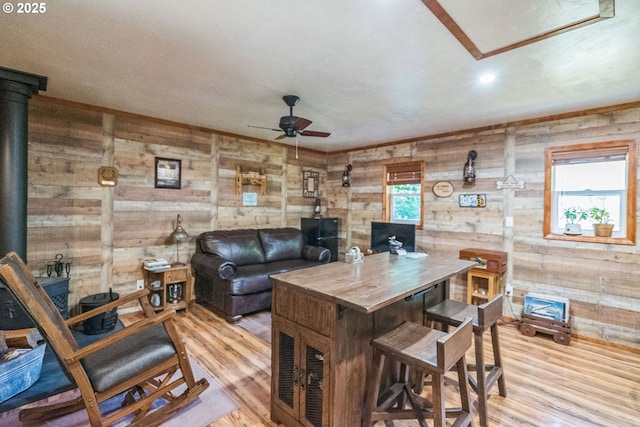 241 Jackson Rd, Cook, WA 98605 - living area with a ceiling fan, light wood-style flooring, wood walls, and a wood stove