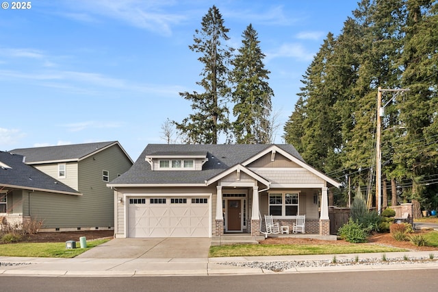 view of front of house with a garage, covered porch, and a front yard