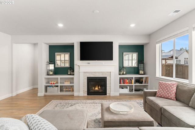 living room with a fireplace and hardwood / wood-style floors