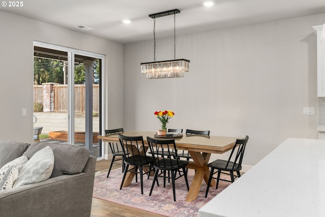 dining room featuring an inviting chandelier and wood-type flooring