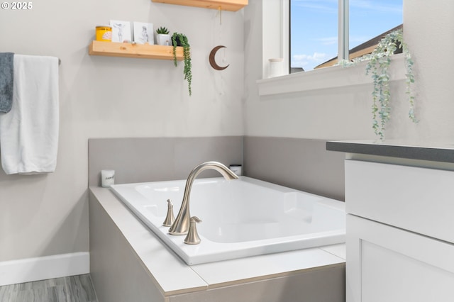 bathroom with a relaxing tiled tub