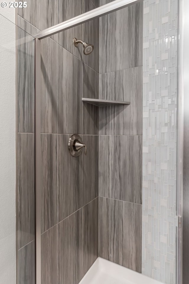 bathroom with a tile shower