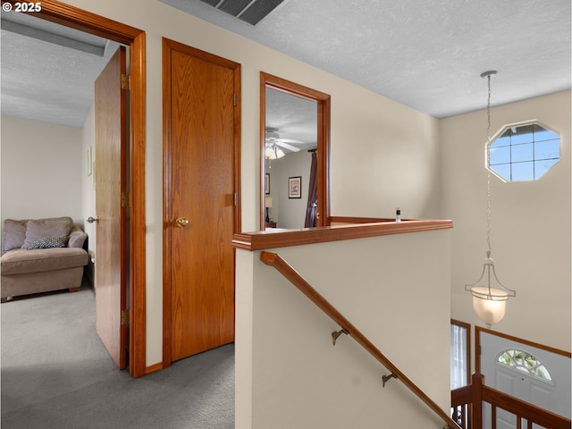 67 NW Orchard Pl, Gresham, OR 97030 - hallway featuring carpet flooring, a textured ceiling, and an upstairs landing