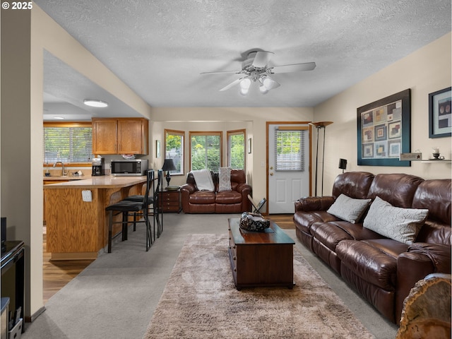 67 NW Orchard Pl, Gresham, OR 97030 - living room featuring a ceiling fan, a textured ceiling, and light carpet