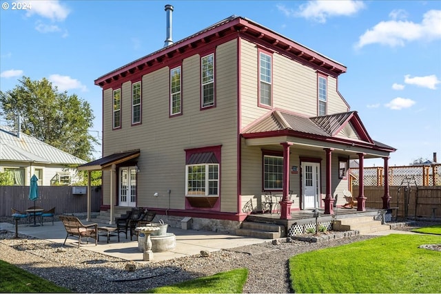 exterior space featuring a patio area, fence, and a lawn