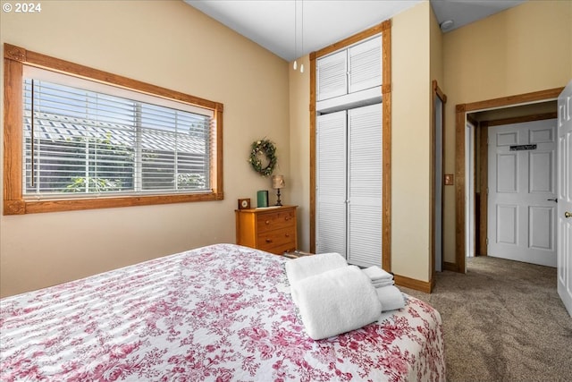 carpeted bedroom with a closet and baseboards