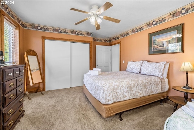 bedroom featuring a closet, light carpet, and ceiling fan