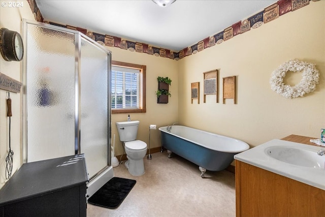 full bath featuring a stall shower, a freestanding tub, vanity, and toilet