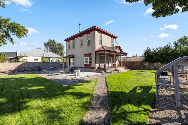 back of house with a patio area, a yard, and a fenced backyard