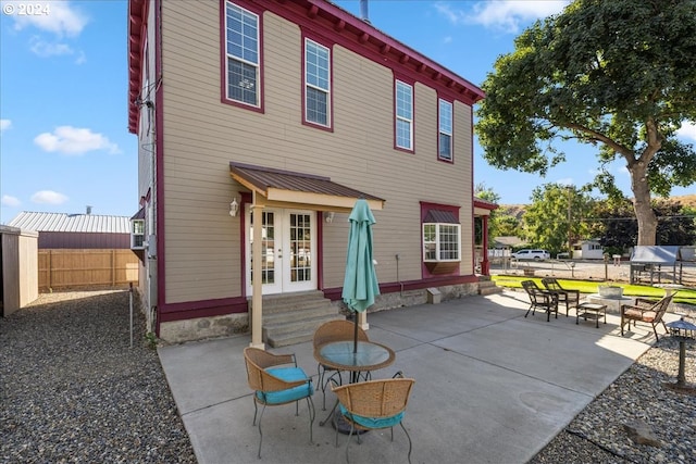 back of house with entry steps, a patio, and fence