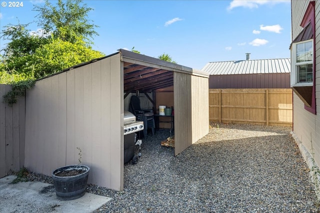 view of outbuilding featuring fence