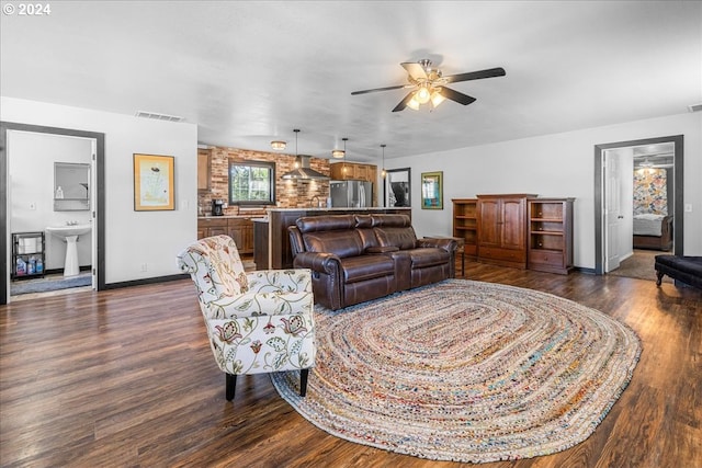 living room with baseboards, visible vents, ceiling fan, and dark wood-type flooring