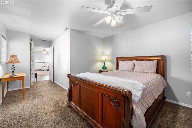 bedroom with a ceiling fan, visible vents, baseboards, multiple windows, and dark carpet