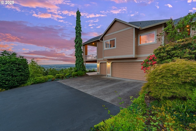 335 Runyan Rd, Woodland, WA 98674 - view of side of property featuring asphalt driveway and a garage