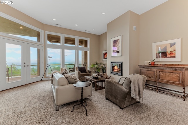 335 Runyan Rd, Woodland, WA 98674 - living room with french doors, a glass covered fireplace, carpet flooring, and recessed lighting