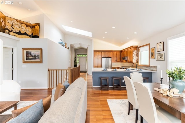 626 SE 38th Dr, Gresham, OR 97080 - dining space featuring a skylight, light wood finished floors, recessed lighting, and lofted ceiling