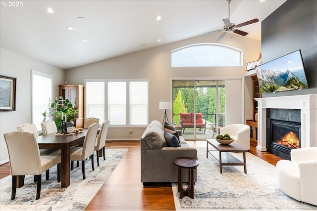 626 SE 38th Dr, Gresham, OR 97080 - living room with lofted ceiling, a glass covered fireplace, wood finished floors, a ceiling fan, and recessed lighting