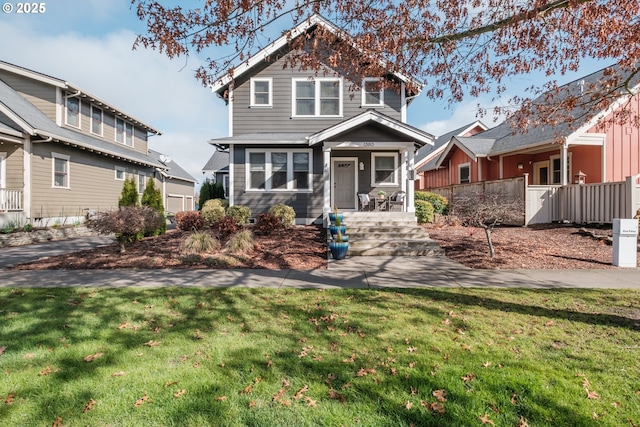 view of front facade with a front yard and covered porch