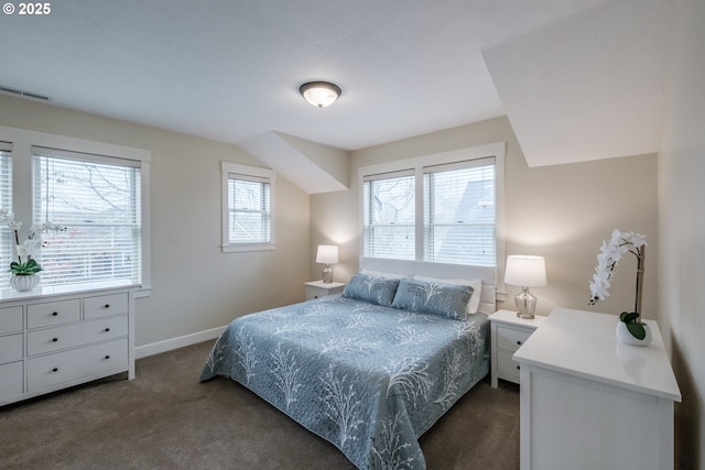 bedroom featuring dark colored carpet, visible vents, and baseboards