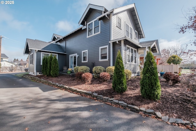 view of home's exterior featuring fence