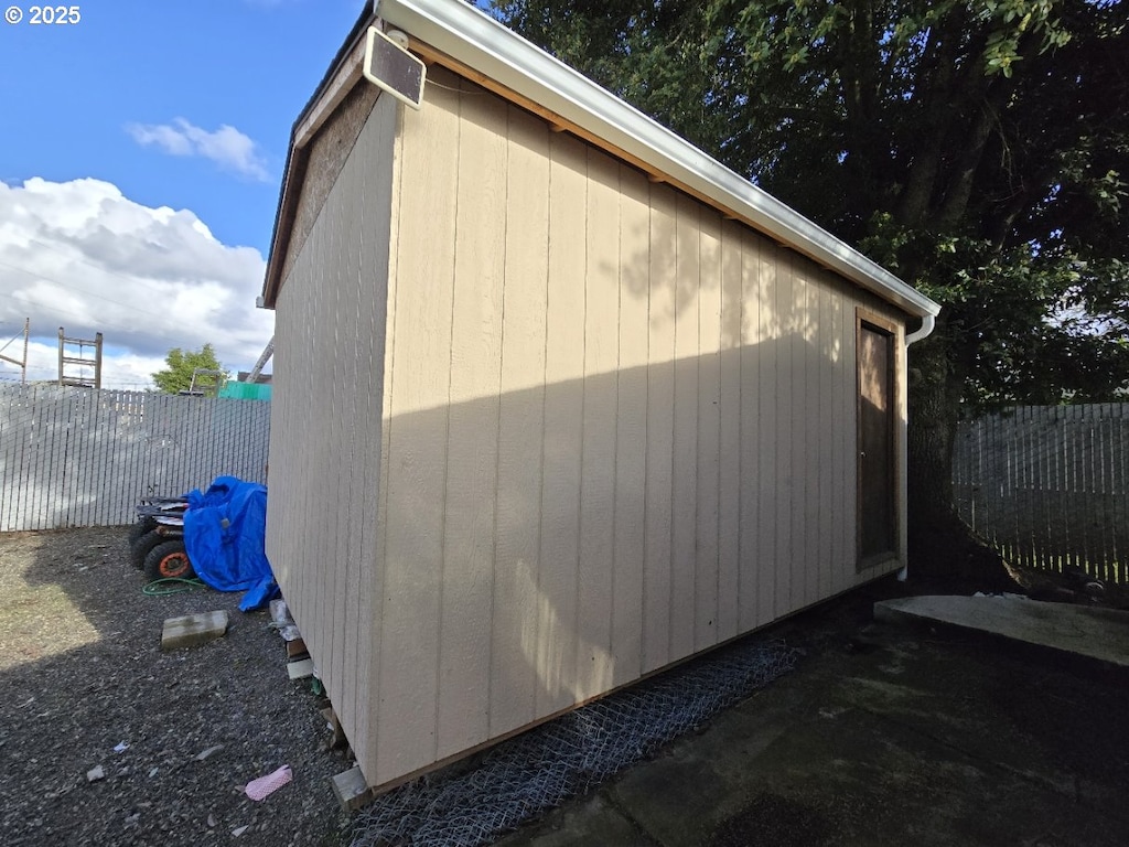 view of side of home featuring fence