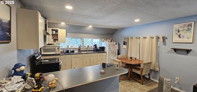 94191 Seaview Ln, Gold Beach, OR 97444 - kitchen with white appliances, a sink, dark countertops, recessed lighting, and a peninsula