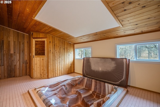 bedroom featuring wooden walls and wooden ceiling